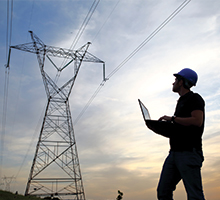 Utility worker looking at power line